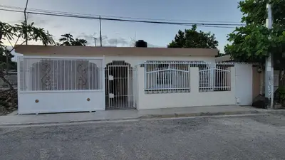 a white garage with a gate on a street at Descansa sin prisas a minutos del Aeropuerto in La Caleta