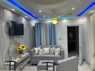 a living room with a couch and a tv at Moderna casa cerca de el aeropuerto SDQ y mi rent cars in La Caleta