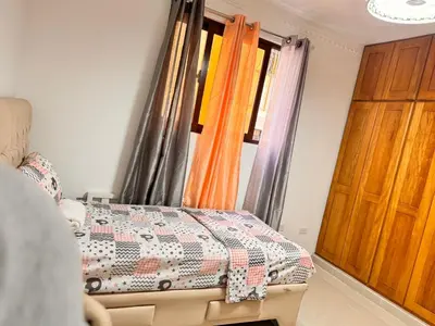a bedroom with a bed and a window at Santiago Amazing 4bedrooms Apt for group, spectacular WIFI, close to all fun in Santiago de los Caballeros