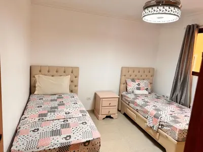a bedroom with two beds and a night stand at Santiago Amazing 4bedrooms Apt for group, spectacular WIFI, close to all fun in Santiago de los Caballeros
