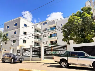 a truck parked in front of a white building at Santiago Amazing 4bedrooms Apt for group, spectacular WIFI, close to all fun in Santiago de los Caballeros