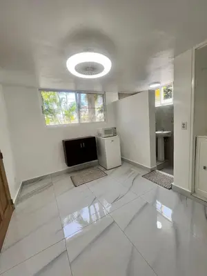 an empty room with a white tile floor and a window at Hermosa villa frente al mar in San Felipe de Puerto Plata