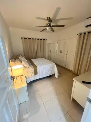 a bedroom with a bed and a ceiling fan at Hermosa villa frente al mar in San Felipe de Puerto Plata
