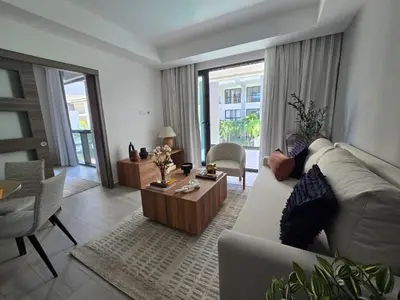 a living room with a couch and a table at Apartamento a estrenar con acceso privado a la playa in Punta Cana
