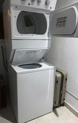 a microwave oven sitting on top of a refrigerator at Lujoso apartamento cerca del aeropuerto SDQ in La Caleta