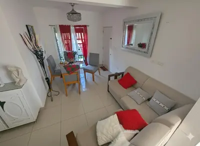 a living room with a couch and a table at Elegant apartment within a gated residential complex- 10 mins from Cabarete in Gaspar Hernández
