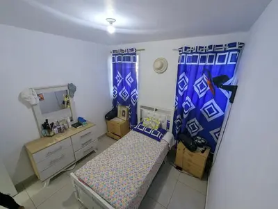 a small bedroom with a bed and a mirror at Elegant apartment within a gated residential complex- 10 mins from Cabarete in Gaspar Hernández