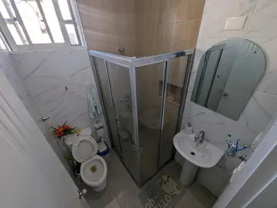 a bathroom with a shower and a toilet and a sink at Elegant apartment within a gated residential complex- 10 mins from Cabarete in Gaspar Hernández