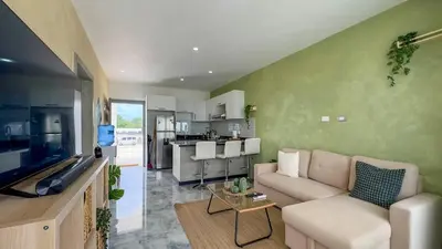 a living room with a couch and a kitchen at Oceanfront Escondido Bay Laguna Beach in Sosúa