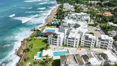 an aerial view of a beach with white buildings at Oceanfront Escondido Bay Laguna Beach in Sosúa