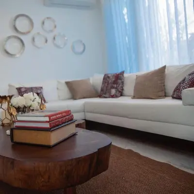 a living room with a white couch and a coffee table at Caribbean getaway Villa 30 in Puerto Plata