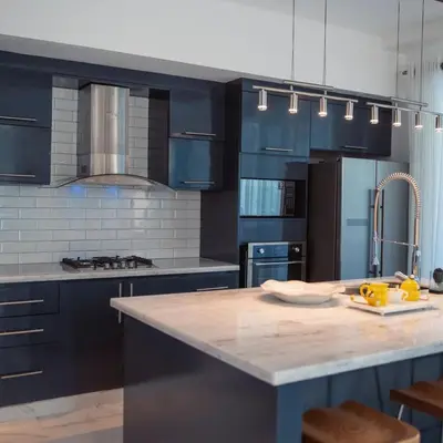 a kitchen with blue cabinets and a marble counter top at Caribbean getaway Villa 30 in Puerto Plata