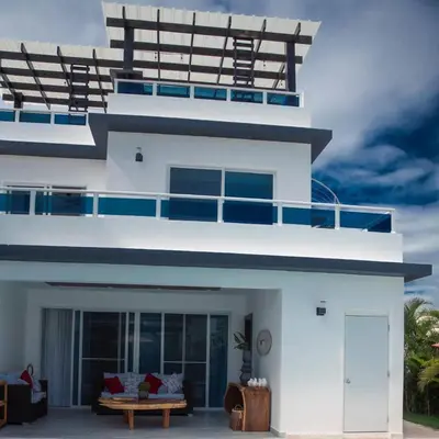 a white house with a balcony on top of it at Caribbean getaway Villa 30 in Puerto Plata