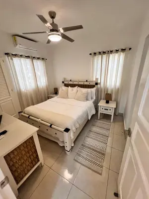 a bedroom with a bed and a ceiling fan at Paraiso frente al mar in San Felipe de Puerto Plata