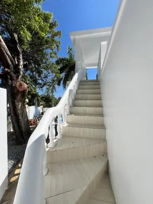 a staircase leading up to a white house at Paraiso frente al mar in San Felipe de Puerto Plata