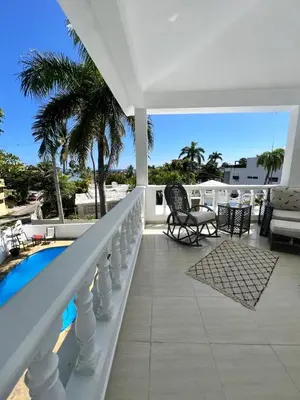a balcony of a house with a swimming pool at Paraiso frente al mar in San Felipe de Puerto Plata