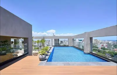 a swimming pool on the roof of a building at Luxury 2-Bed Condo in Piantini Sauna, Gym, & Pool in Santo Domingo