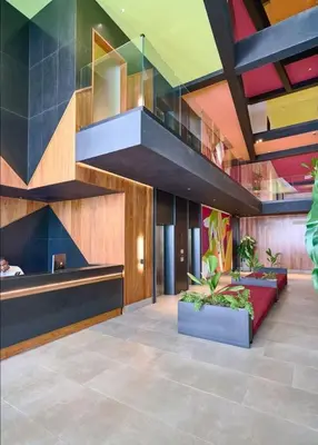 a lobby with a staircase in a building at Luxury 2-Bed Condo in Piantini Sauna, Gym, & Pool in Santo Domingo