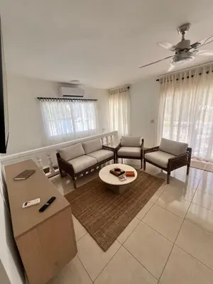 a living room with a couch and a table at ocean view tropical in Maggiolo