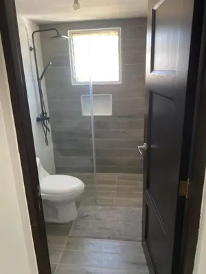 a bathroom with a toilet and a glass shower door at Luxury Villa in Muñoz, Puerto Plata in Puerto Plata