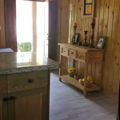 a kitchen with a wooden counter and a wooden floor at Villa Monte Alba in San Felipe de Puerto Plata