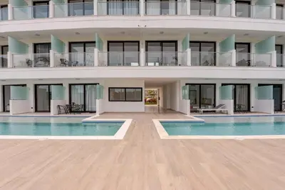 a large building with a swimming pool in front of it at Cana Rock Universe in Punta Cana