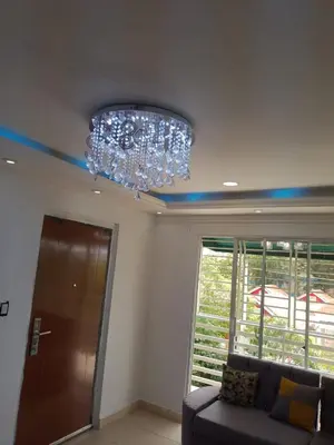 a chandelier in a living room with a couch at Alojamiento M&M in Los Paredones