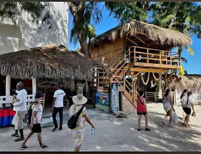 a group of people standing outside of a hut at Palmar Apartments Comfort Great Location in Punta Cana