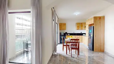 a kitchen and dining room with a table and chairs at Palmar Apartments Comfort Great Location in Punta Cana
