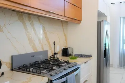 a kitchen with a stove top oven in a kitchen at Newly Built Luxury Private 3 Bedroom Pool Villa in Sosúa