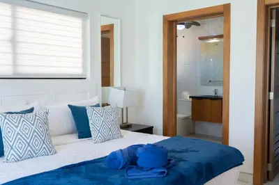 a bedroom with a bed with a blue towel on it at Newly Built Luxury Private 3 Bedroom Pool Villa in Sosúa