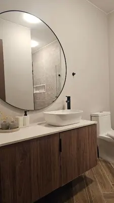 a bathroom with a sink and a large mirror at Luxury 2-Bed Condo in Piantini Sauna, Gym, and Pool in Santo Domingo