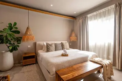 a bedroom with a bed and a table and a window at New* 3BR Loft | Pool | Patio | 2 mins to Beach in Las Terrenas