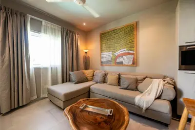 a living room with a couch and a table at New* 3BR Loft | Pool | Patio | 2 mins to Beach in Las Terrenas