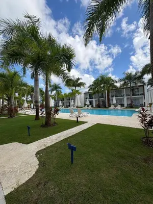 a resort with a swimming pool and palm trees at Boca paraiso in Boca Chica