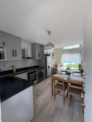 a kitchen and living room with a table and chairs at Boca paraiso in Boca Chica