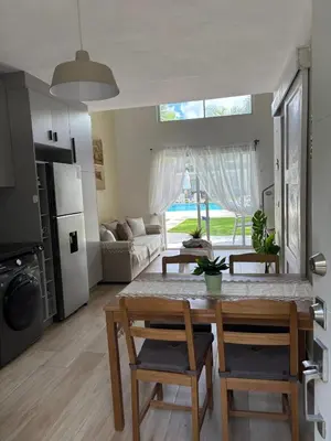 a kitchen and living room with a table and chairs at Boca paraiso in Boca Chica