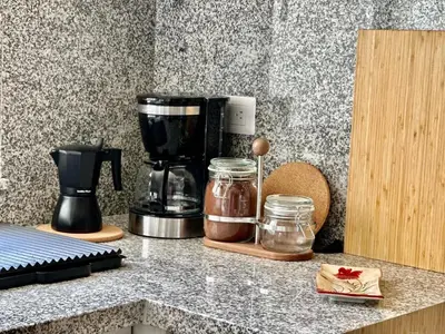 a counter with a coffee maker and jars on it at Corner 2BDR in Coral Bay 2 in front of Hard Rock in Punta Cana