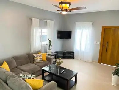 a living room with a couch and a table at Villa Ferrer I in Jarabacoa