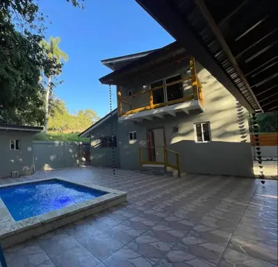 a house with a swimming pool in front of it at Villa Ferrer II in Jarabacoa