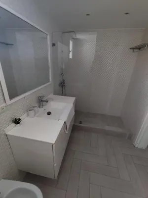 a white bathroom with a sink and a shower at Luxury apartment Tracadero 2 Bedrooms Sea Pools access Private Garden Workspace in La Laguna