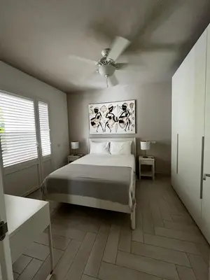 a bedroom with a bed and a ceiling fan at Luxury apartment Tracadero 2 Bedrooms Sea Pools access Private Garden Workspace in La Laguna