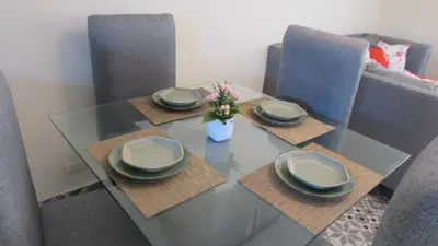 a dining room table with plates and flowers on it at Style and Comfort in Cancino