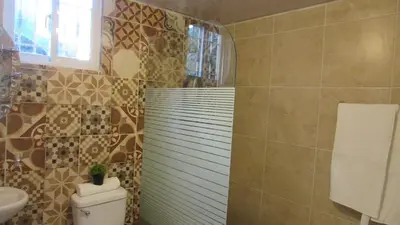 a bathroom with a toilet and a sink at Style and Comfort in Cancino