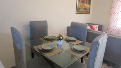 a dining room table and chairs with a glass table and sidx sidx sidx at Style and Comfort in Cancino