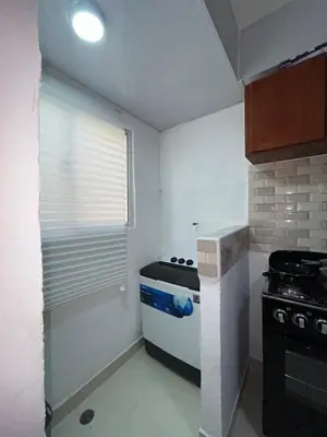 a small kitchen with a stove and a window at Comfortable apartment near the airport in La Javilla