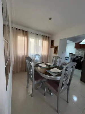a dining room table and chairs in a kitchen at Comfortable apartment near the airport in La Javilla