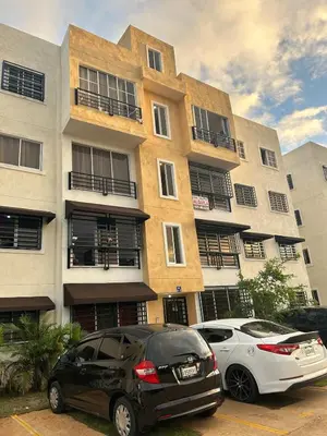 two cars parked in a parking lot in front of a building at Comfortable apartment near the airport in La Javilla
