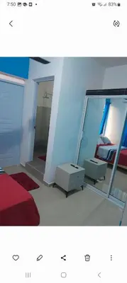 two pictures of a bedroom with a bed and a mirror at Apartamentos La Mina in Manuel Chiquito