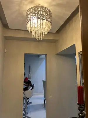 a chandelier hanging from a ceiling in a room at Jove-Bita Tower in Santo Domingo